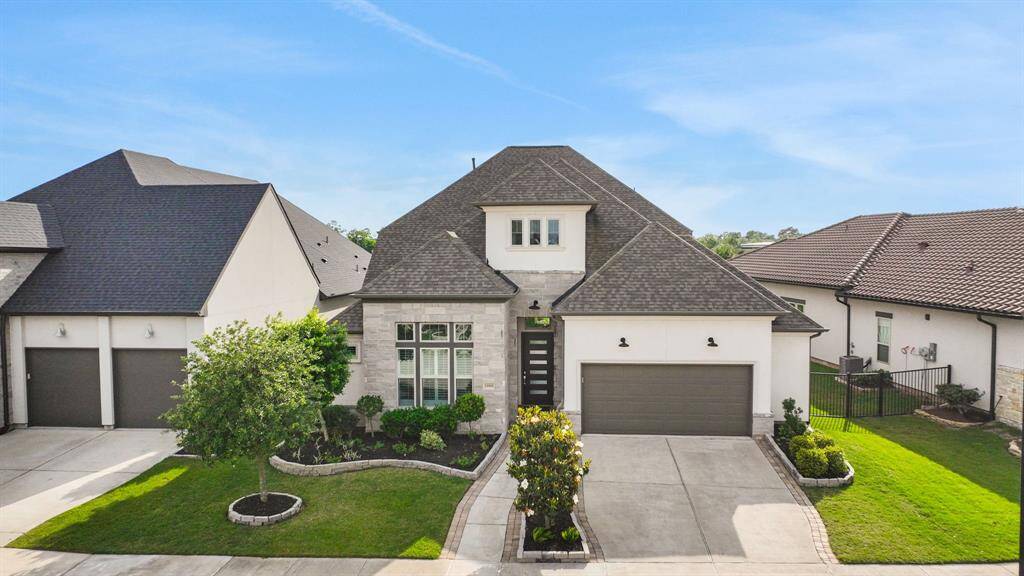 The tandem three car garage is oversized and has room for storage for a golf cart or workspace.