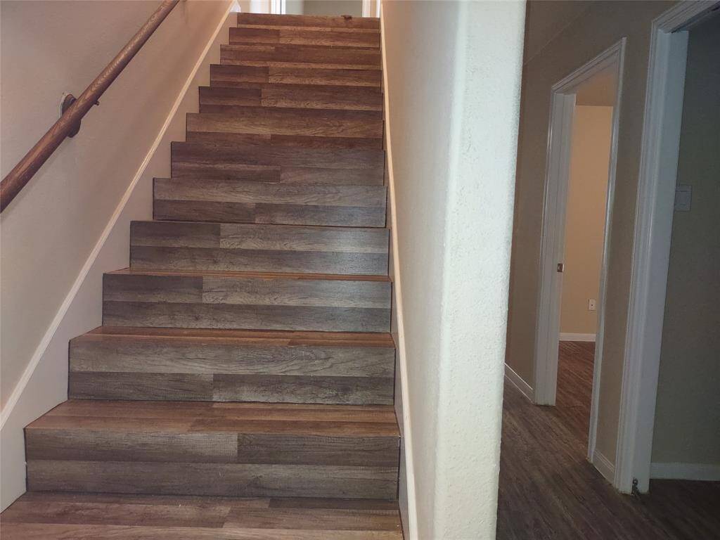 Stairway up to 2 more bedrooms and a full bathroom