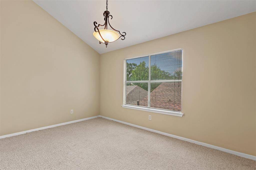 View of the loft area located upstairs with carpet and large picture window.