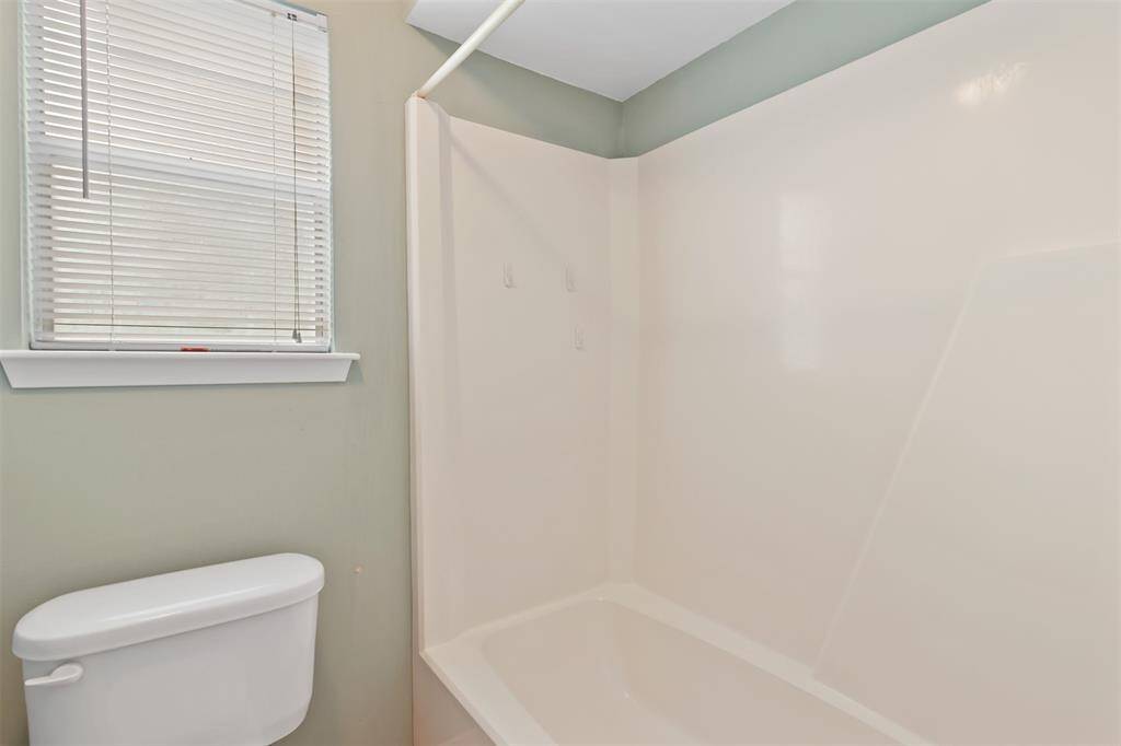view of the tub/shower combo located in the secondary full bathroom.