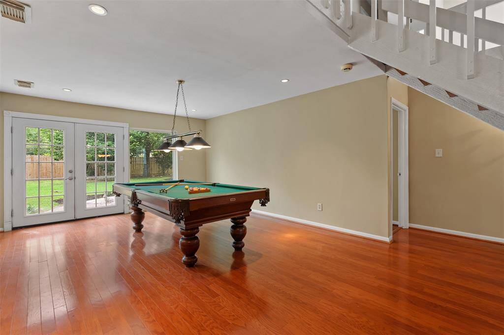 The breakfast room is spacious with wood floors and double window panned doors leading out into the backyard.