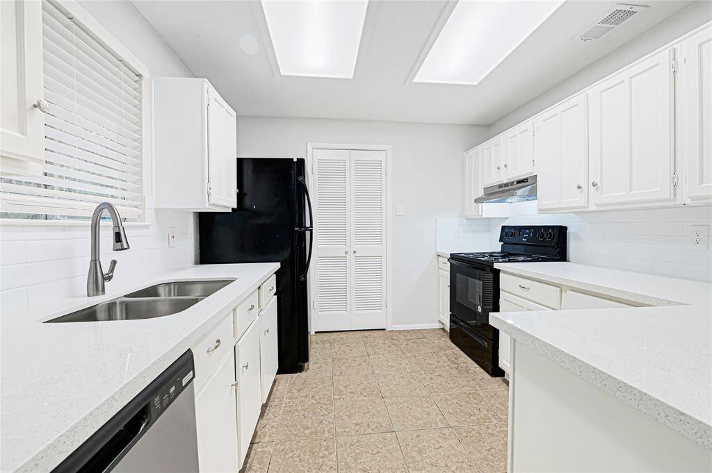 The kitchen features sparkling quartz counter tops, white subway tile backsplash and crisp white cabinetry.