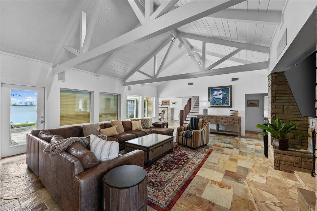 Safety and style come together in this spacious living room, featuring hurricane shutters for peace of mind.