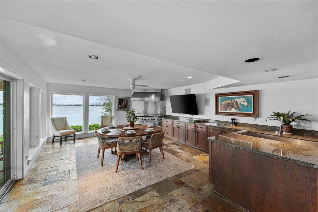 Start your mornings with lake views in this charming breakfast nook, just steps from a spacious kitchen with granite counters and rich wood cabinetry.