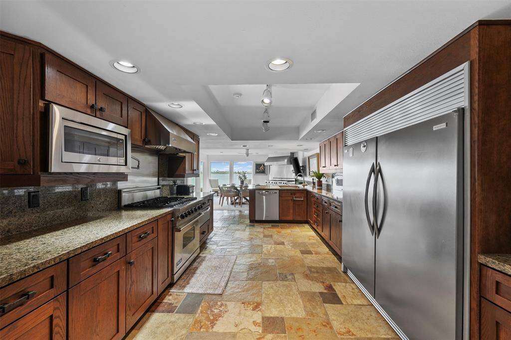 From the heart of the kitchen, enjoy this open view to the breakfast nook and lake—showcasing the perfect flow and spacious layout.