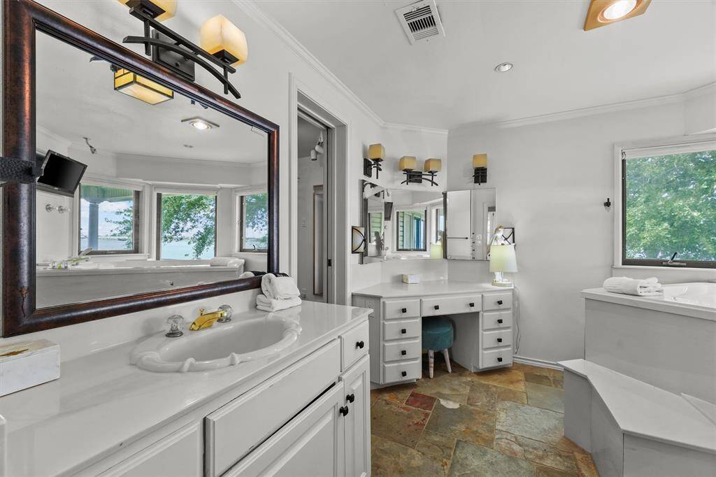 The vanity features ample counter space and tons of storage creating a perfect spot for your daily routine.