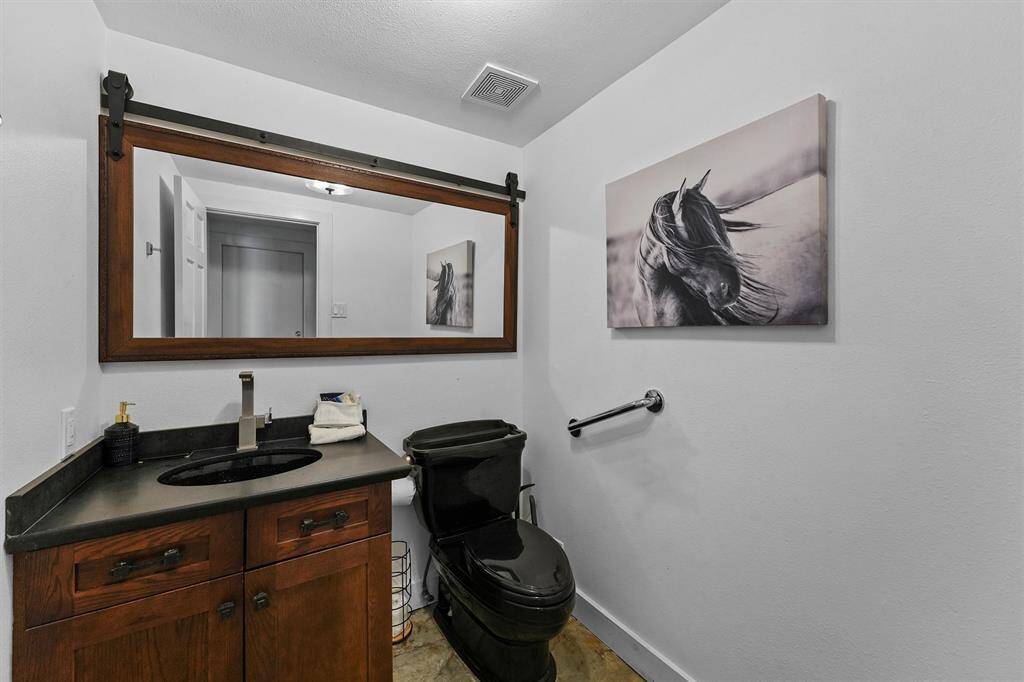 This stylish half bath is perfectly situated near the living area and kitchen, offering easy access.