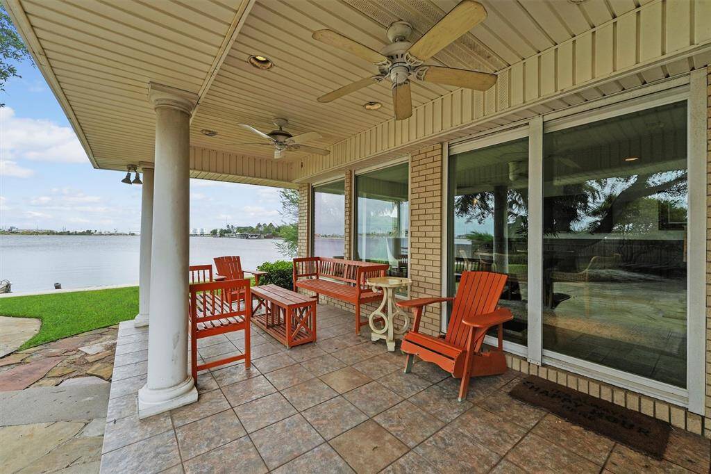 Relax on this tiled patio with ceiling fans, while enjoying peaceful views.