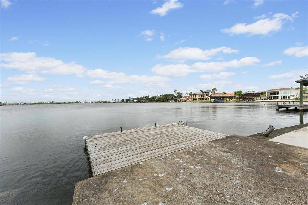 A small dock extends into the water, offering the perfect spot to launch a kayak or simply relax and enjoy the views.