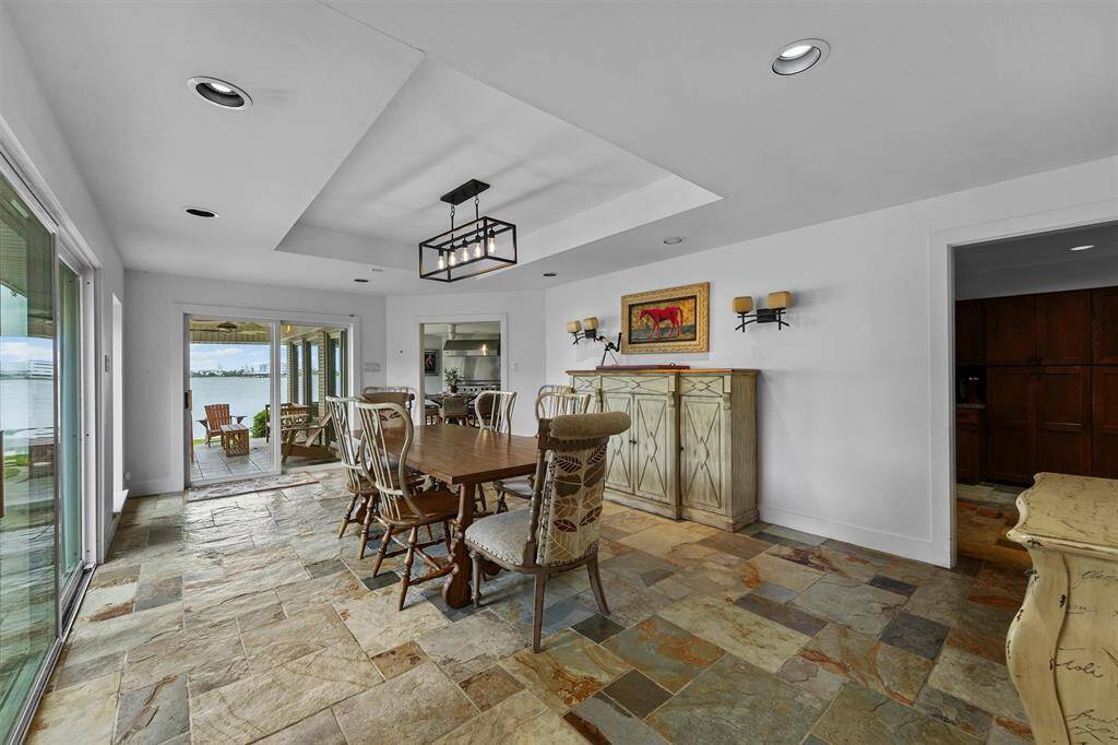 Dine in style with water views! This bright space offers indoor-outdoor flow perfect for hosting.