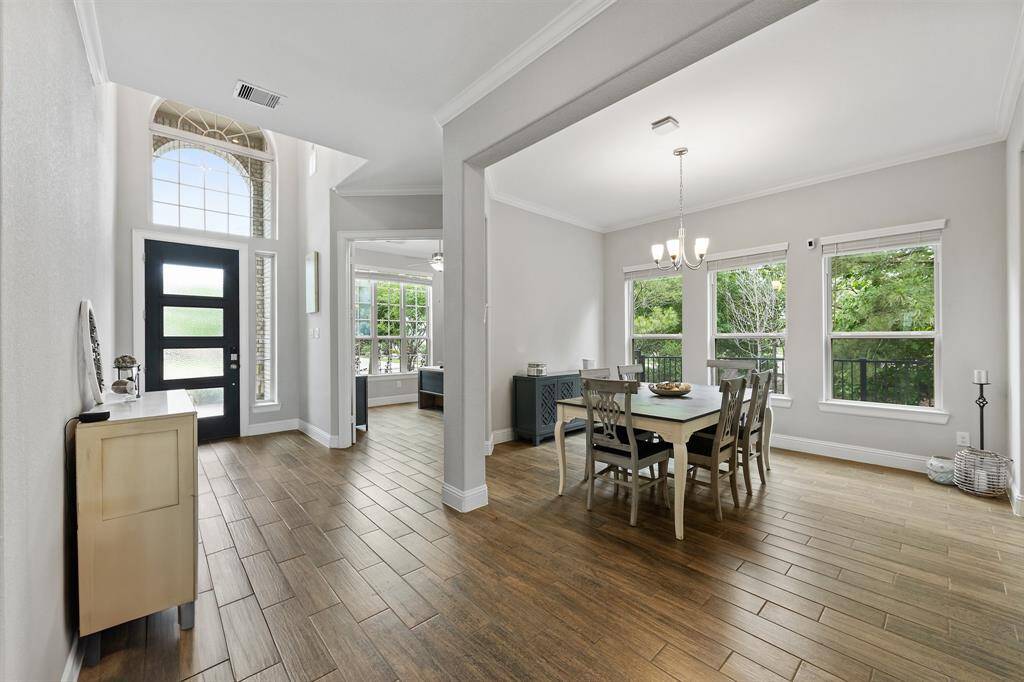 As you enter through the front door, you're greeted by elegant crown molding on each one of the walls and its light grey color enhancing the natural light flowing through the windows.