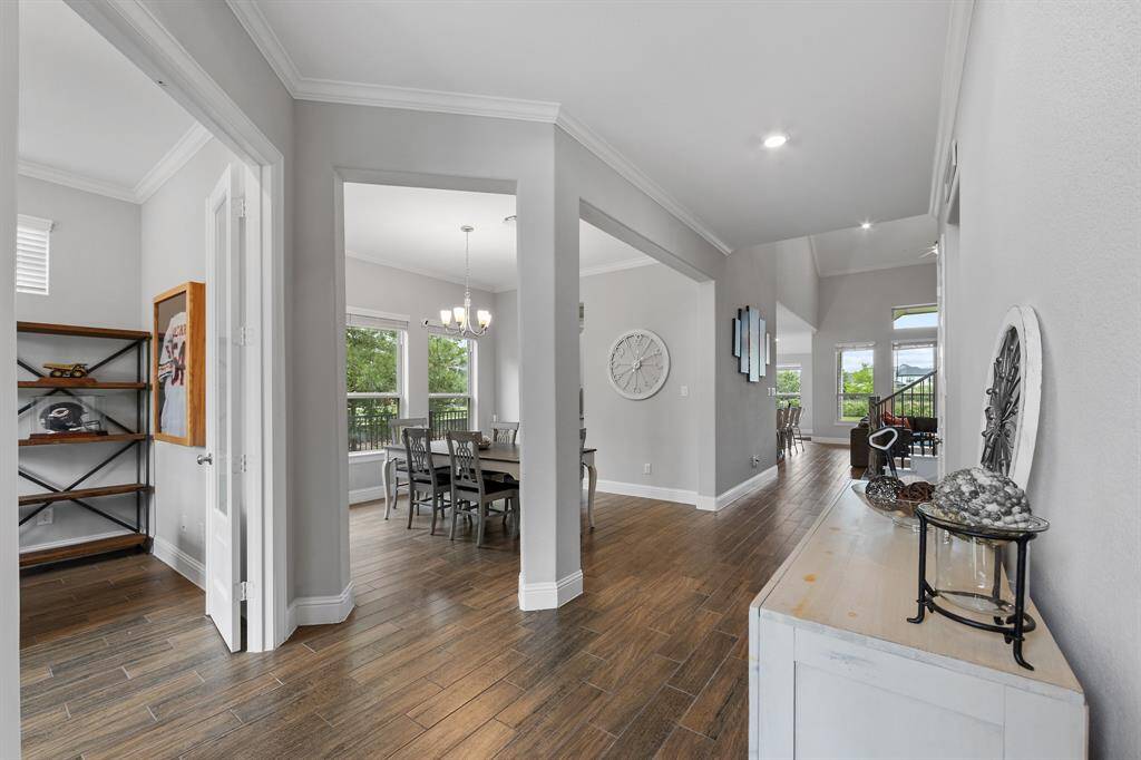 Rich wood-look tile plank flooring extends throughout the main living areas since the front entrance, offering the perfect blend of warmth, durability, and low-maintenance elegance.