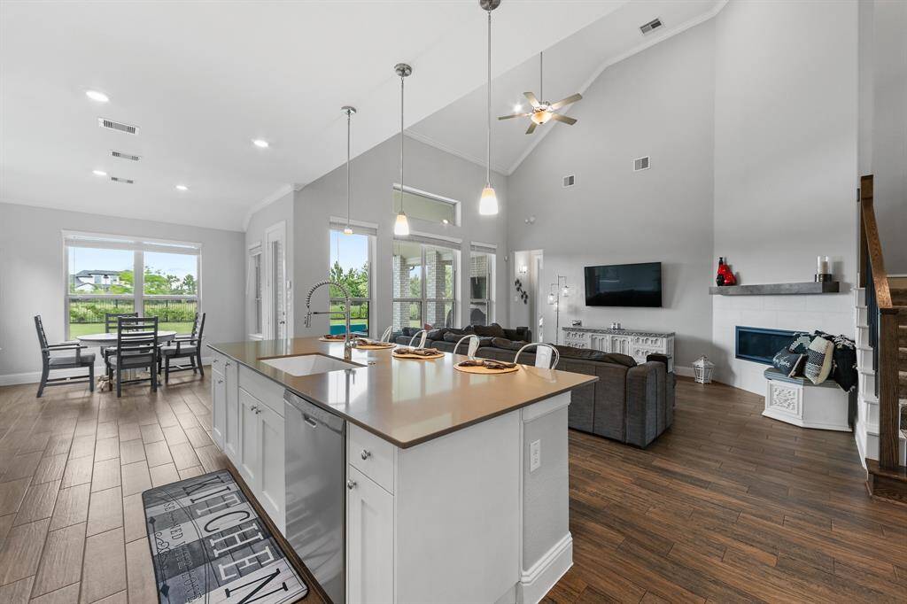 The gourmet island kitchen features a massive central island, perfect for meal prep and gatherings. Enhanced with sleek granite and quartz countertops right next to the family room!