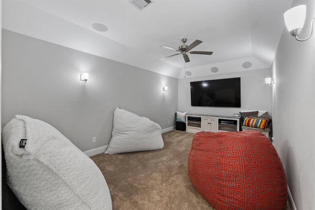 Just above the stairs, this space provides versatile room features plush carpet flooring and a ceiling fan for any use.