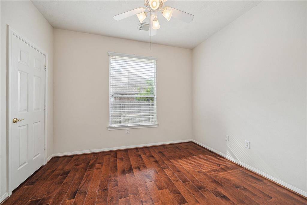 This naturally lit secondary bedroom is a cozy and inviting space for your loved ones.