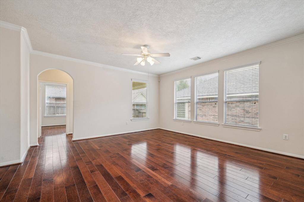 This alternate view of the living room highlights its graceful design and abundant natural light, a truly inviting and elegant space.