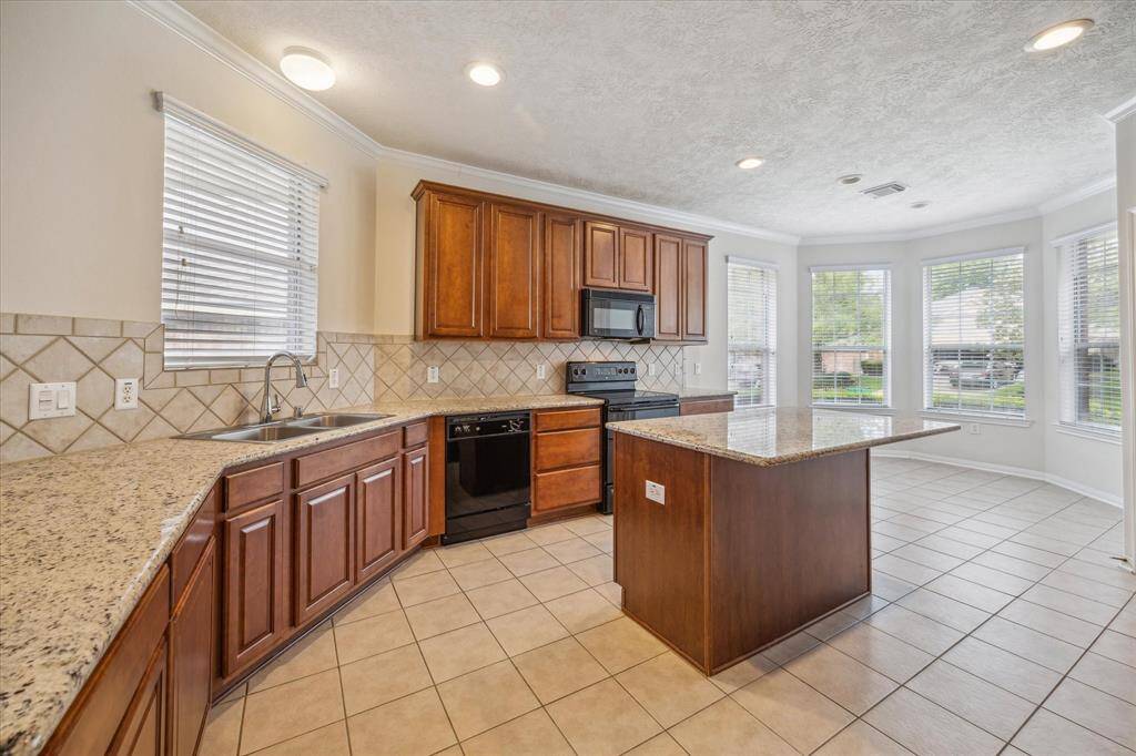 Beautiful and spacious kitchen featuring elegant touches like granite countertops, ample storage, a pantry, and the perfect layout for sharing special moments with loved ones, especially during the holidays.
