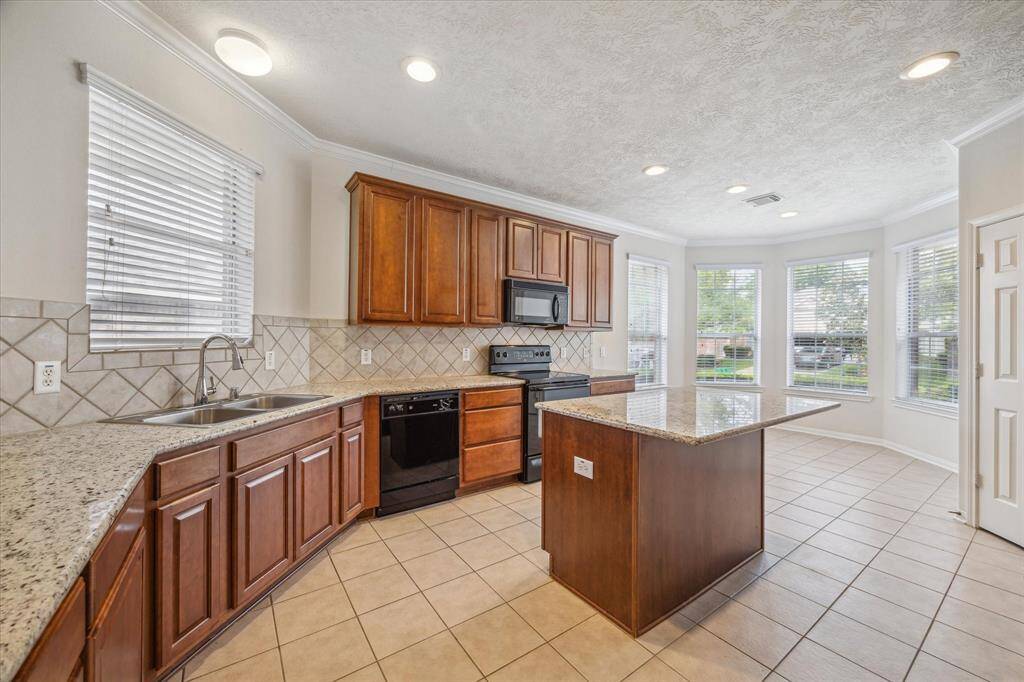 Take in the spacious and light-filled kitchen, with a cozy breakfast area, a convenient pantry to the right, and a refrigerator included, a space you’re sure to fall in love with.