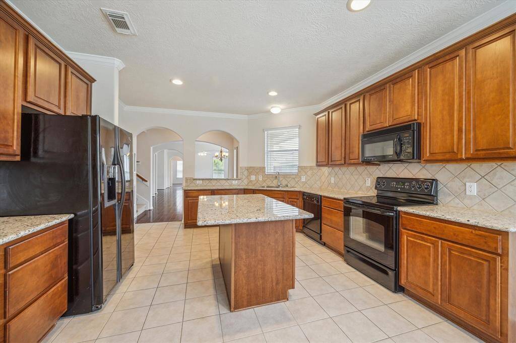 From this angle, you can appreciate just how spacious the kitchen is. This move-in ready home offers both functionality and style.