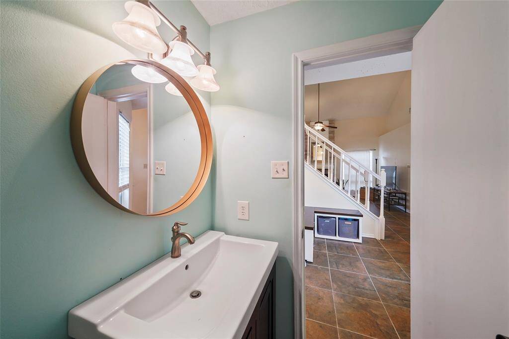 Updated vanity and mirror in the convenient half bath downstairs
