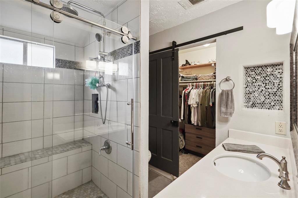 Behind the barn door is a large walk in closet