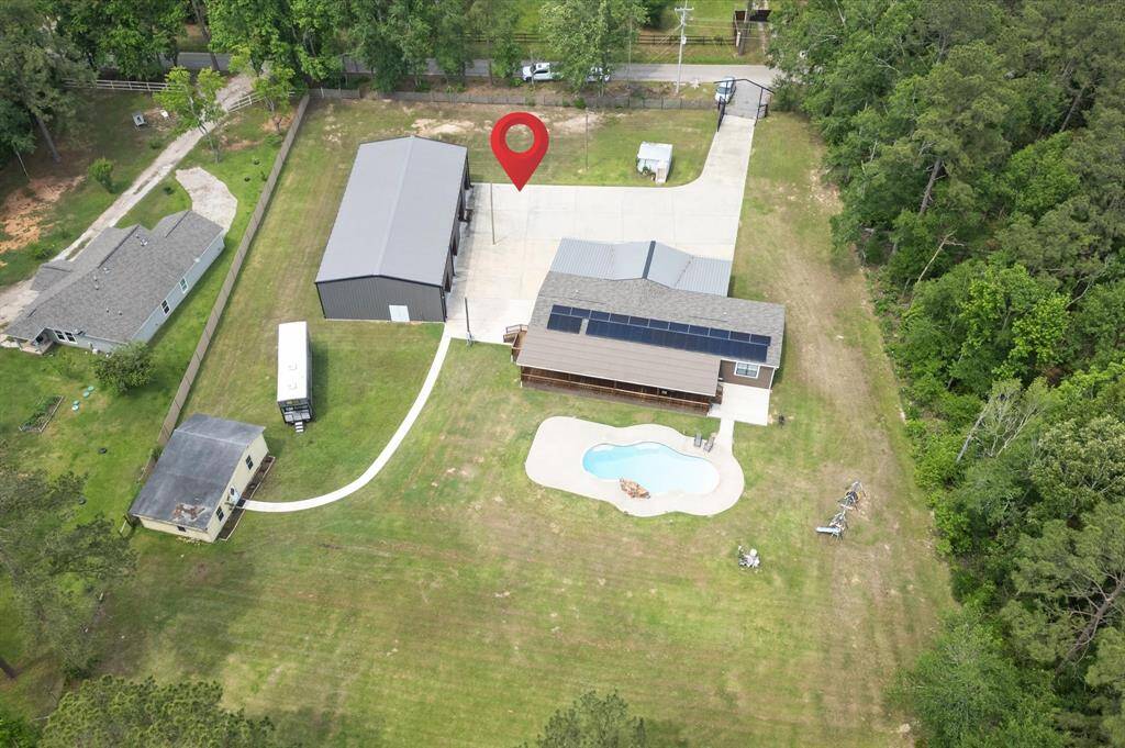 Welcome home! Multiple living spaces and a 4-car garage with workshop space. Nestled on over 3 acres of land!