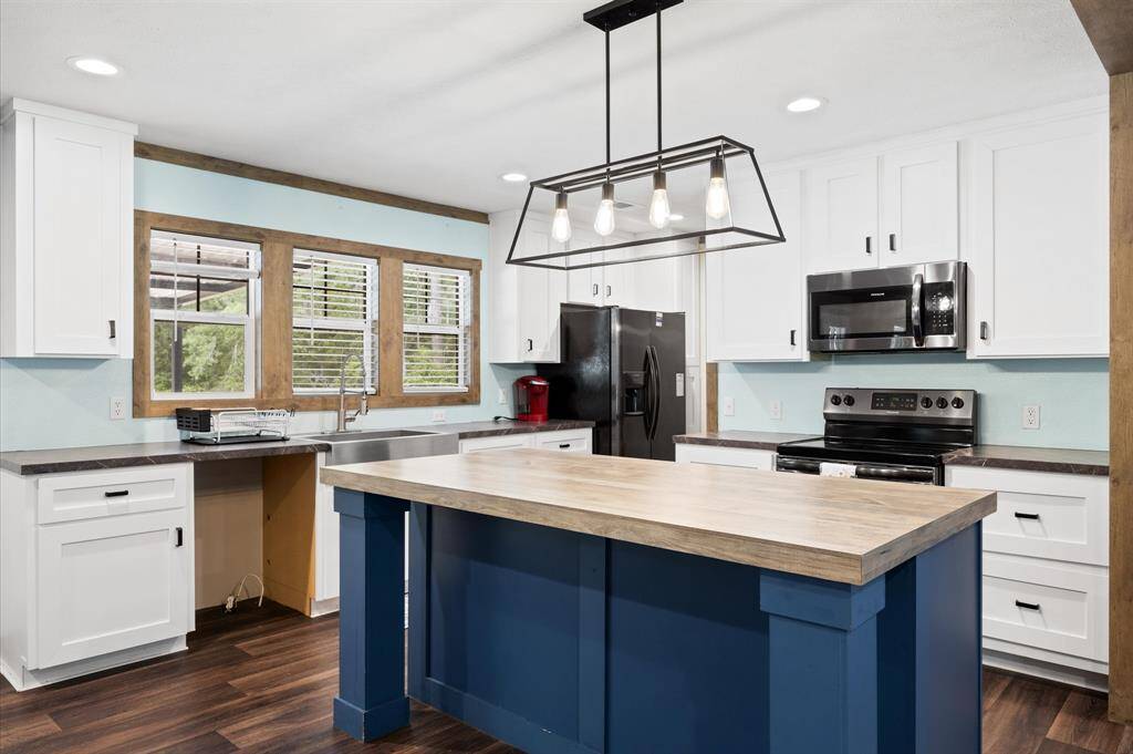 Kitchen island and stainless steel appliances.