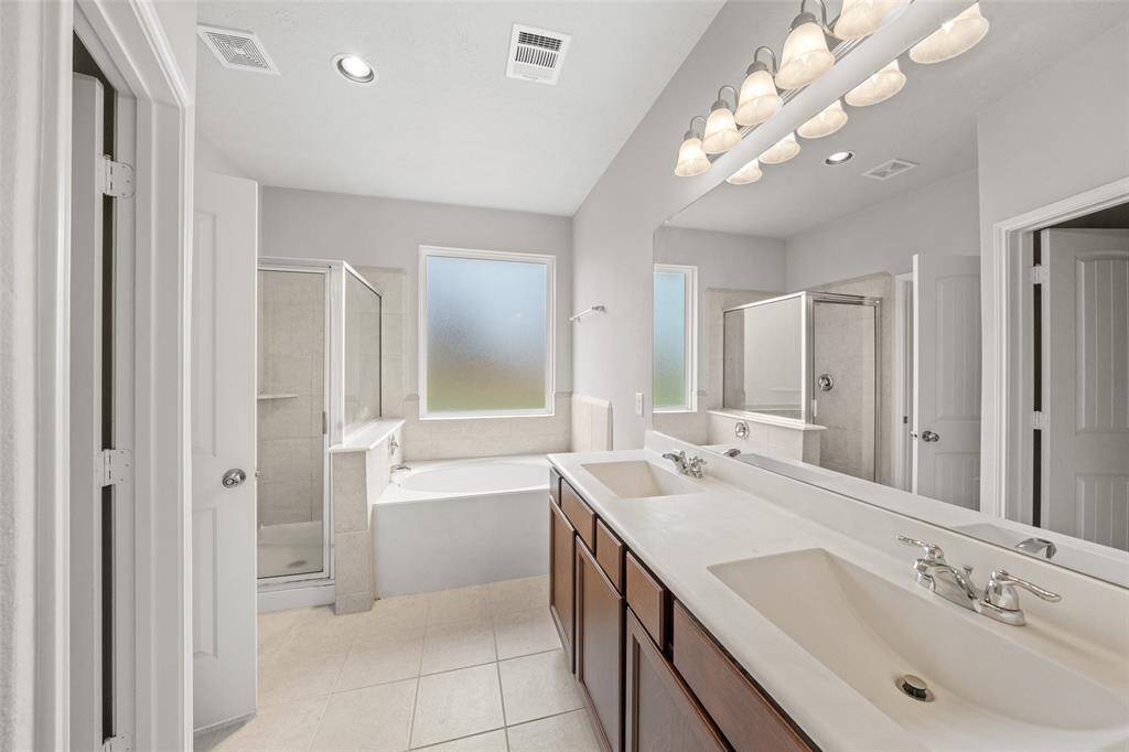 Primary Bathroom; whether you love a shower or a soak in tjhe tub, we can take care of you here. Elegant modern style double sinks and enough Counter space for both of you. Just how many bottles can you get on one counter top - is the challenge here!