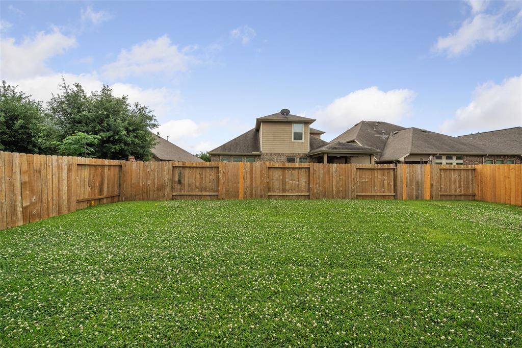 The vast empty Back Yard, just READY FOR NEW CARING OWNERS!!!!   IS THAT YOU?    Whole Fence has been pressure washed, and some minor storm damage taken care of - professionally - Ready! Ready! Ready!