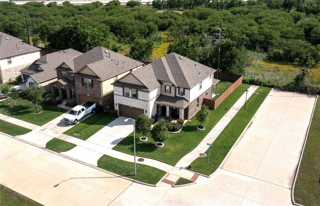 Aerial view of this beautiful home with lovely landscaping.