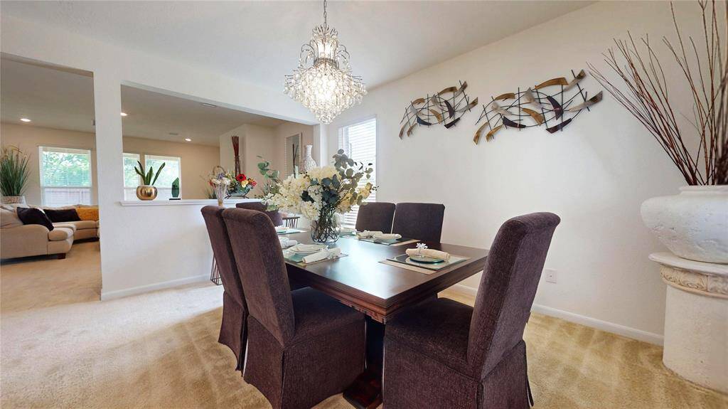 Dining area with a beautiful, stylish chandelier.