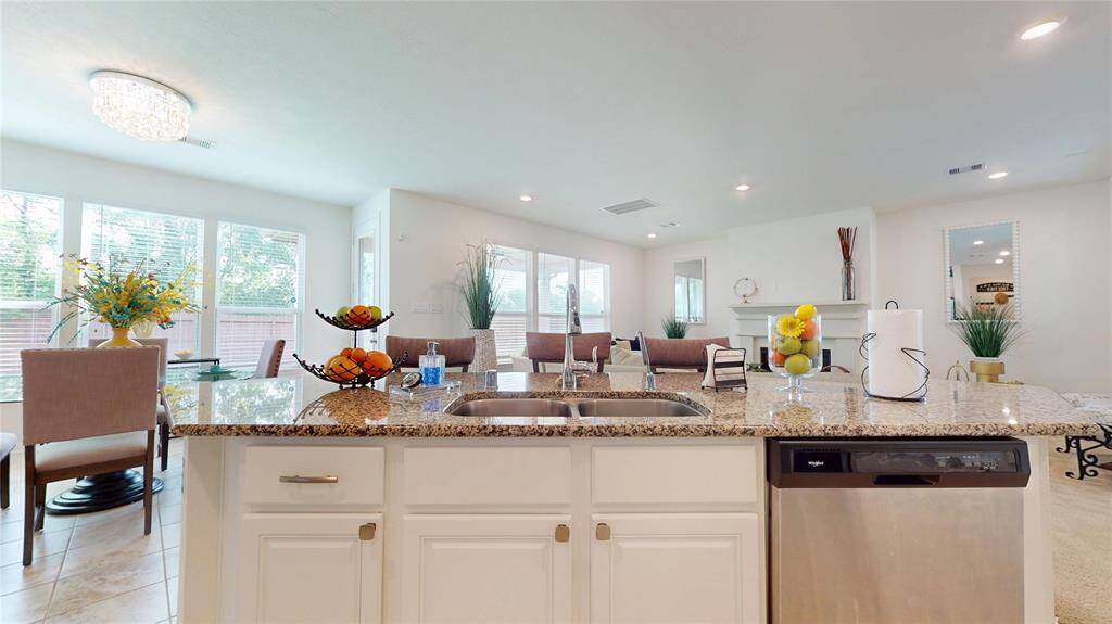 The kitchen, an integral part of this home's open-concept design, seamlessly flows off the living room, creating a harmonious and connected living space.