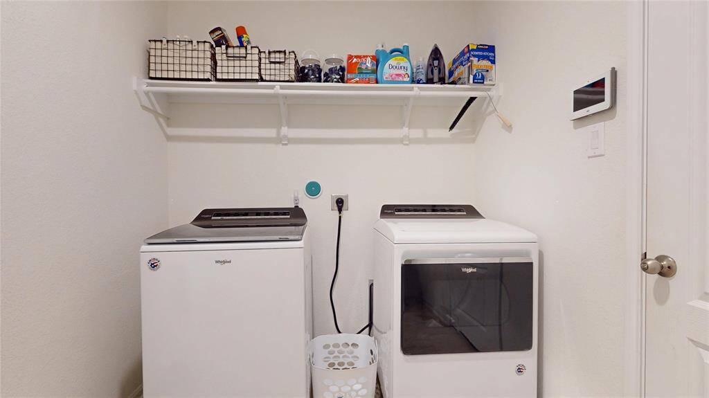 This convenient utility closet easily hides (and is very accessible) with handy storage space, above. Washer and Dryer does not stay.