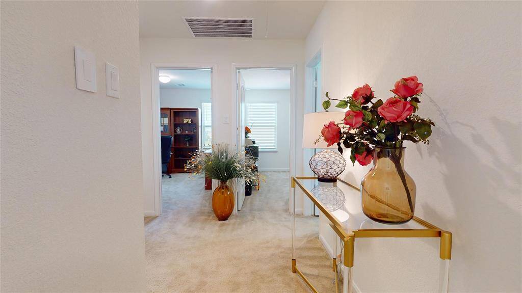 Second floor hallway, the bedrooms are ahead and guest bathroom on the right.