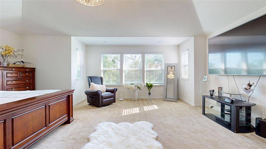 Primary bedroom has plenty of windows allow natural light to fill the room.