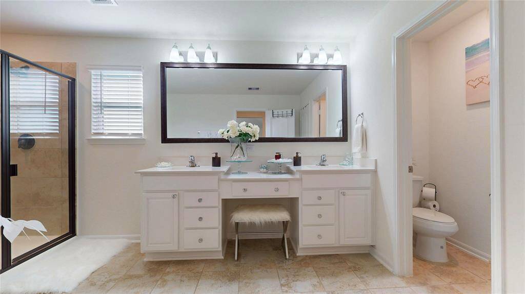 Primary bathroom vanity with his and her sinks.