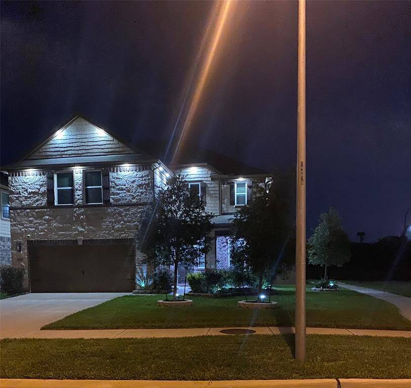 Close-up view of this gorgeous home with plenty of lights at night.