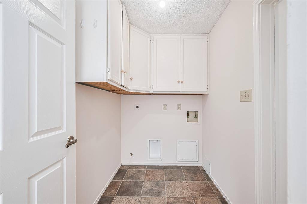 The utility/mud room connects the dining room and garage. Complete with built-in cabinets and both gas & electric dryer connection.