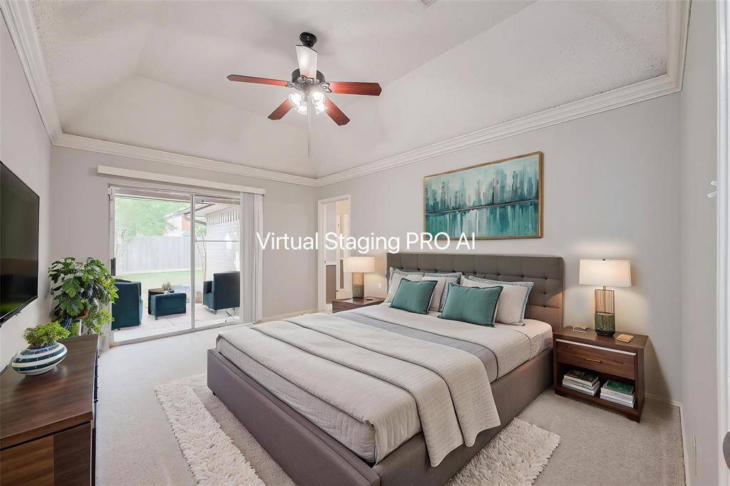 The perfect escape...your spacious ensuite primary bedroom features tall ceilings, crown molding & new carpet. The sliding glass door leads to a private patio, offering natural light and an outdoor view.