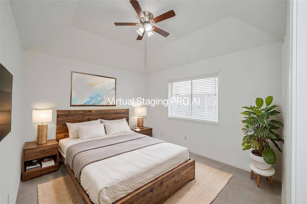 Bedroom 2 has tall ceilings, a ceiling fan, large window and walk-in closet.