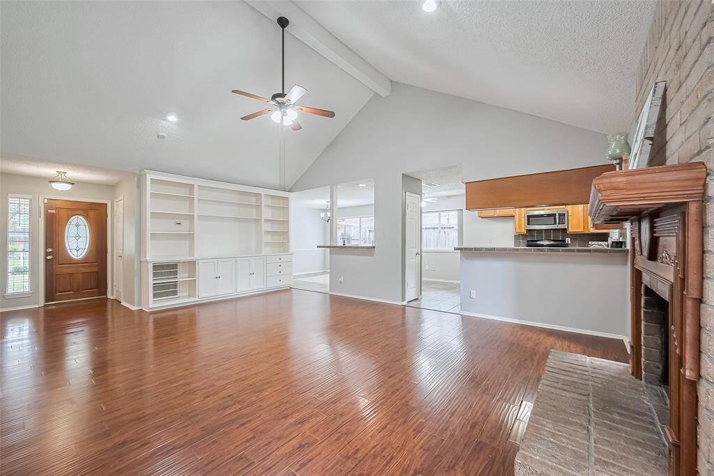 Beautiful architectural details give this home so much character. Vaulted ceiling, exposed beam, two bar tops, brick fireplace, large windows and more.
