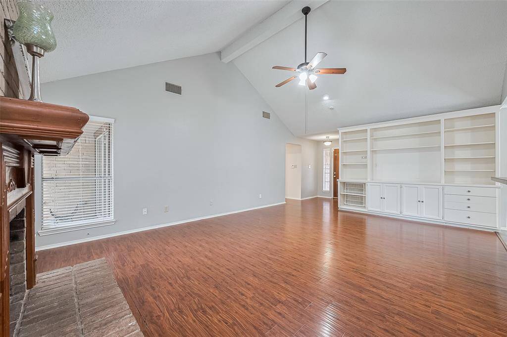 The living room has stylish built-in display shelves & cabinets for all you treasured mementos.