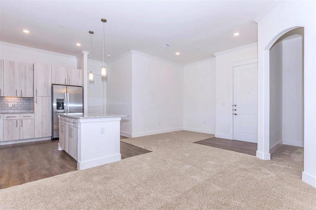 Kitchen with SS appliances, granite countertops, and soft-close drawers, kitchen island with extra storage and breakfast bar. Dining area off of entryway