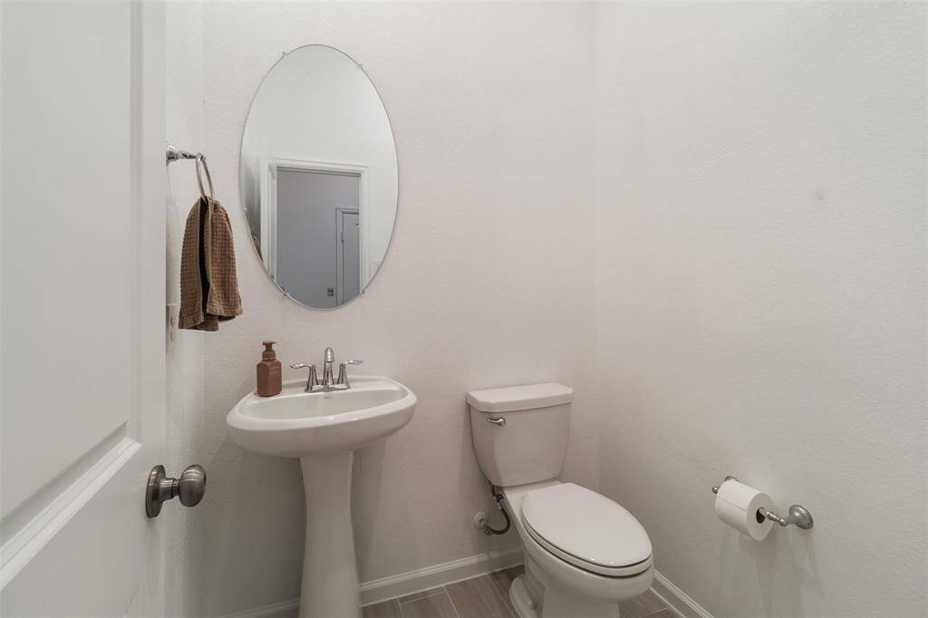 This half bath is great for guests and situated outside of the office area.