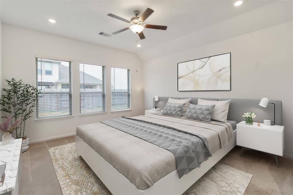 Virtually staged primary bedroom has large windows and plenty space to fit up to a King size bed.