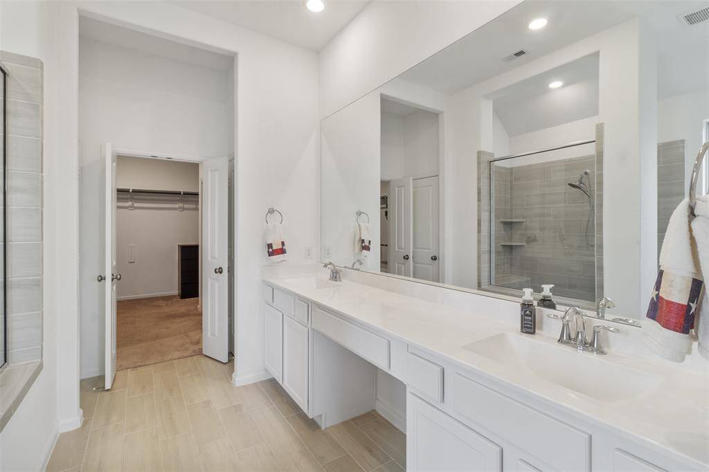 A spacious primary bathroom with double vanities and plenty counter space is perfect for getting ready each day.