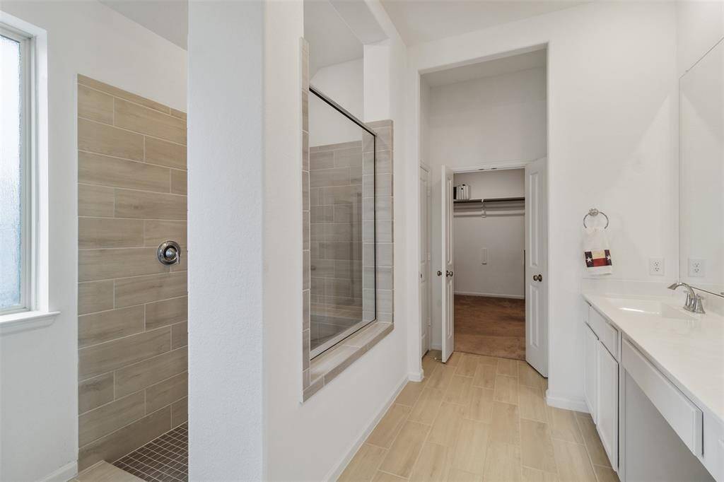 The bathroom leads right into a large closet space.