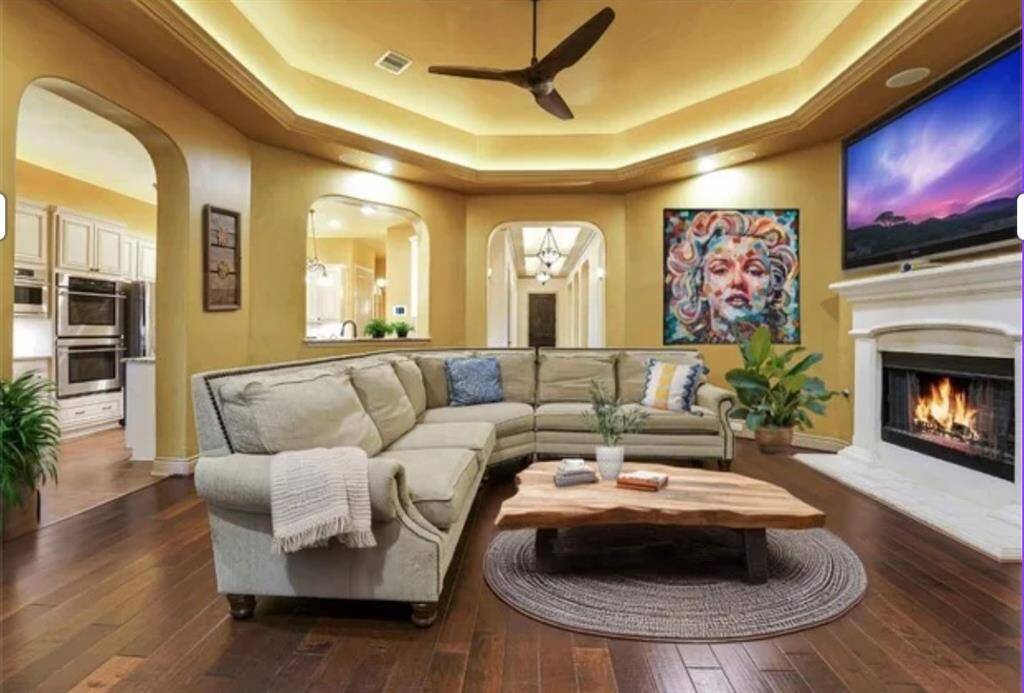Elevate your gatherings in this spacious family room, featuring stylish entertainment lighting.