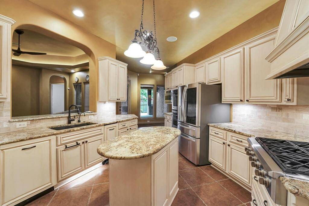 Elevate your living experience with a central kitchen island that seamlessly flows into the inviting living room.
