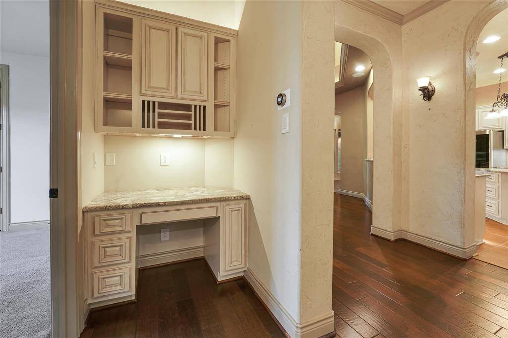 Charming built-in desk with ample shelving and elegant cabinetry, perfect for organization and a stylish touch in your hallway.